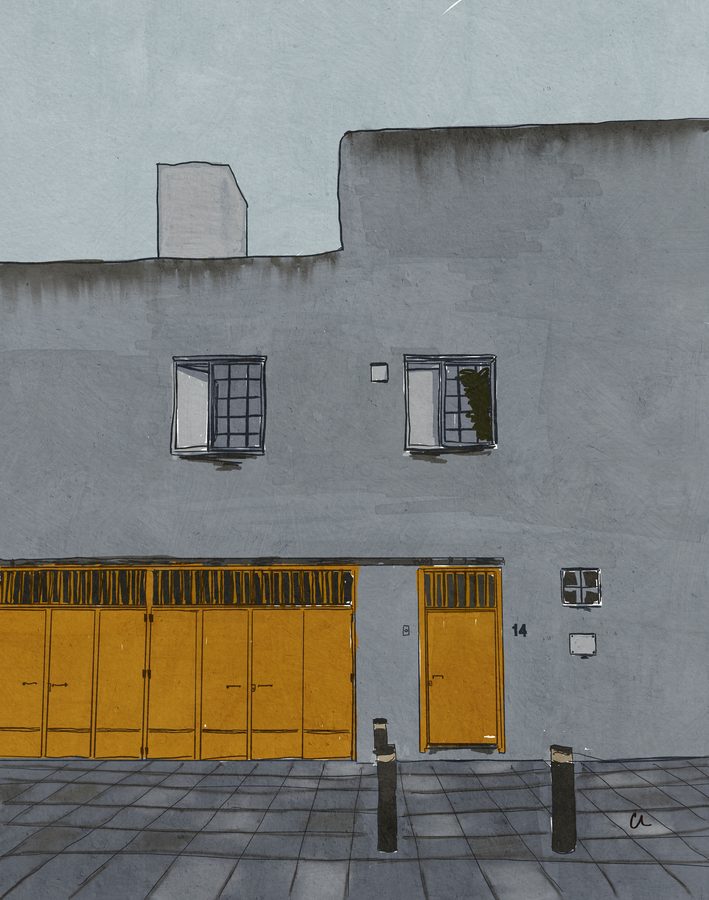 The grey facade of Casa Luis Barragán in Mexico City with its yellow wooden doors